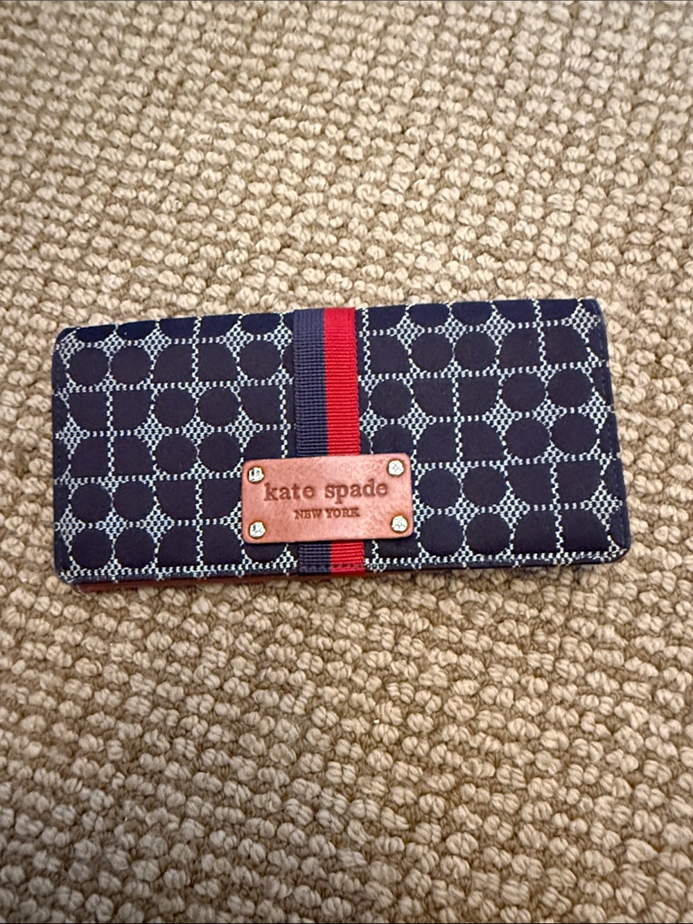 kate spade brown geometric wallet with red and brown accents